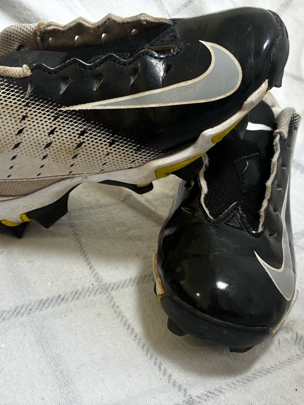 Nike Black and White Athletic Cleats with Gold Trim